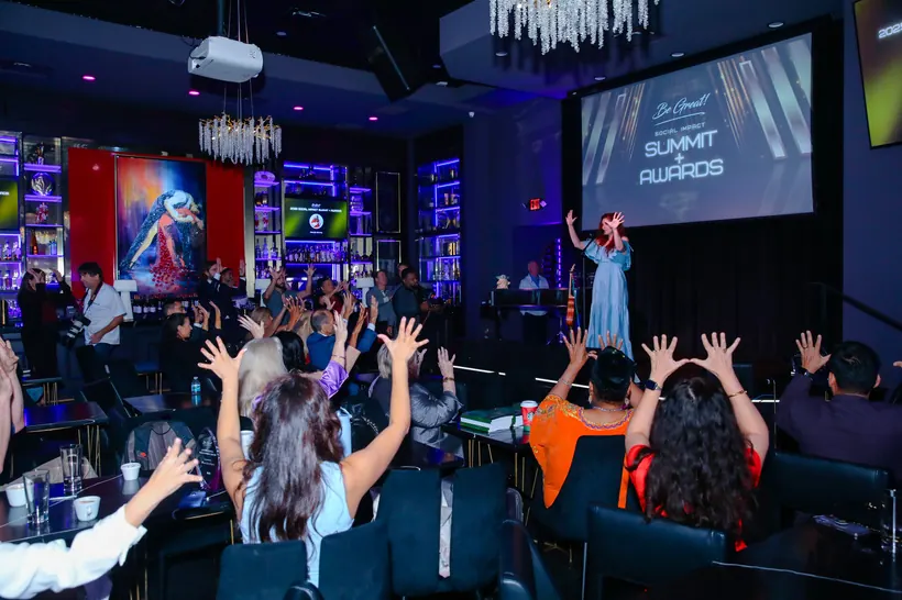 Guests celebrating at the Be Great! Social Impact Summit + Awards