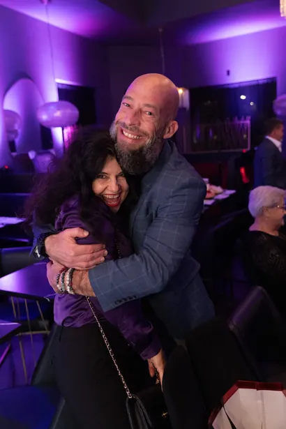 Attendees embracing at the Be Great! Summit